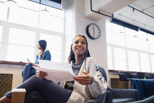 Happy, confident businesswoman with paperwork in office — Stock Photo