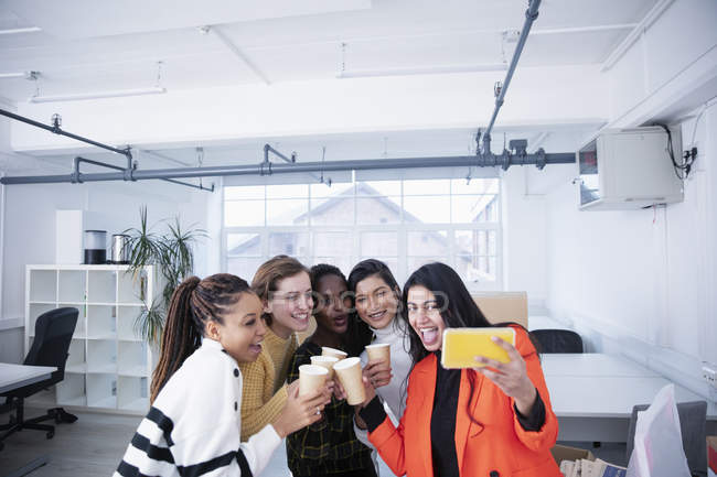 Бізнес-леді святкують новий офіс, беручи селфі — стокове фото