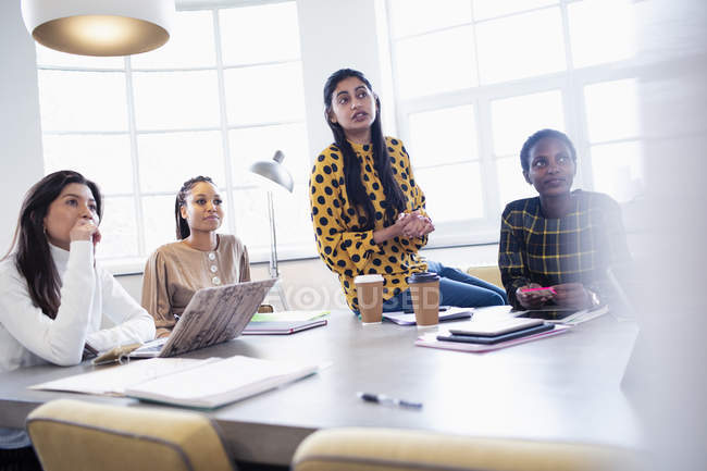 Attentive businesswomen listening in conference room meeting — Stock Photo
