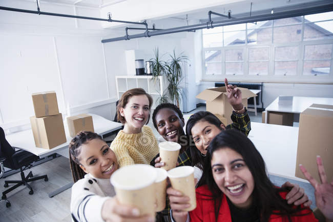 Portrait happy businesswomen celebrating new office — Stock Photo