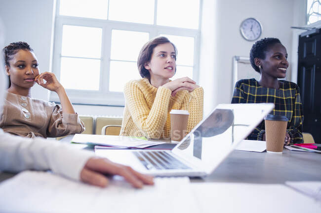 Businesswomen listening in conference room meeting — Stock Photo