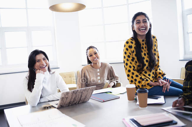 Businesswomen laughing in conference room meeting — Stock Photo