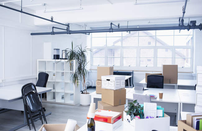 Cardboard boxes in modern, new office — Stock Photo