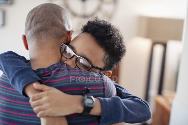 Affectionate son hugging father — Stock Photo