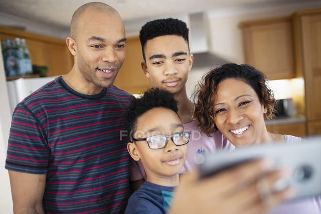 Family taking selfie in kitchen — Stock Photo