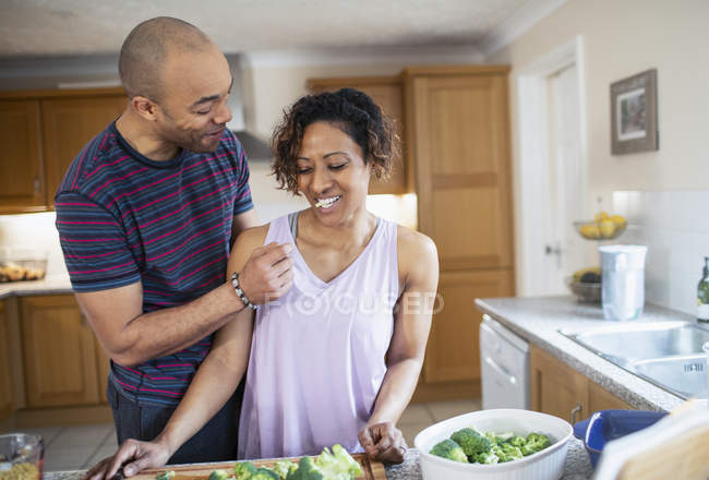 Happy couple cooking in kitchen — Stock Photo