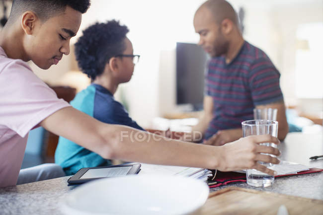 Vater hilft Söhnen bei den Hausaufgaben — Stockfoto