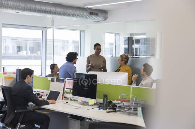 Business people talking, meeting in open plan office — Stock Photo