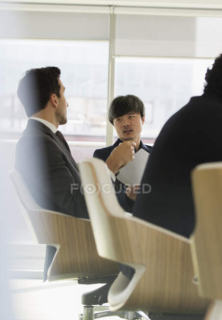 Businessmen talking in conference room meeting — Stock Photo