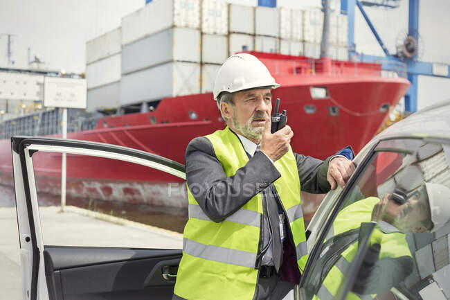 Dock manager using walking-talkie at shipyard — Stock Photo