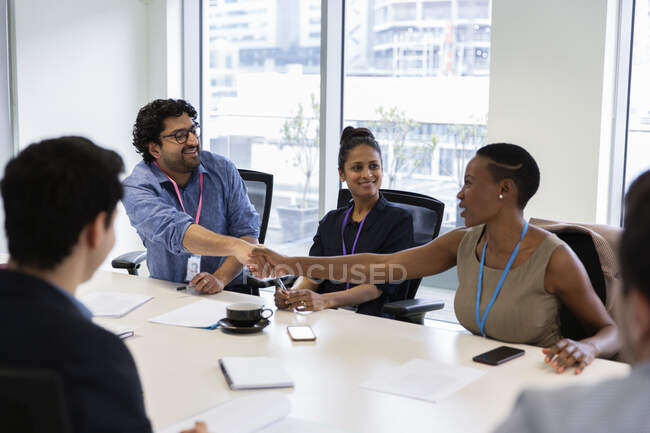 Business people shaking hands in conference room meeting — sit, man - Stock  Photo | #347354006