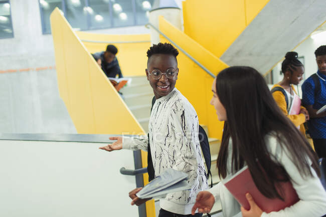 Junior high students talking and walking in corridor — Stock Photo