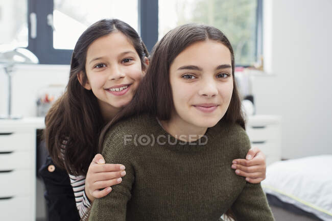 Portrait happy, affectionate sisters at home — Stock Photo