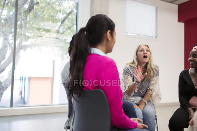 Woman talking in support group meeting circle — Stock Photo