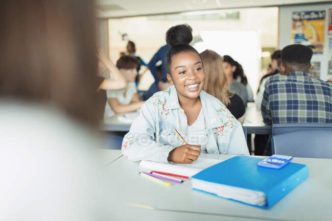 Happy, confident high school girl student studying in classroom — Stock Photo