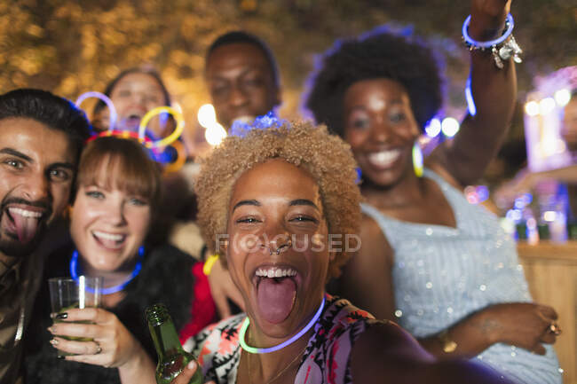 Retrato feliz, exuberantes amigos animando en la fiesta del jardín - foto de stock
