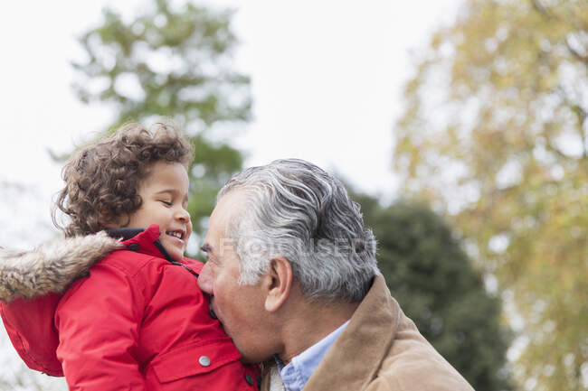 Playful grandfather and grandson in park — Stock Photo