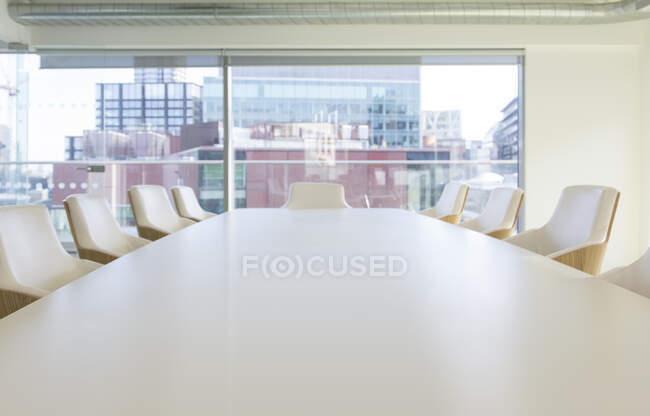 Conference telephone on conference table in urban office — Stock Photo