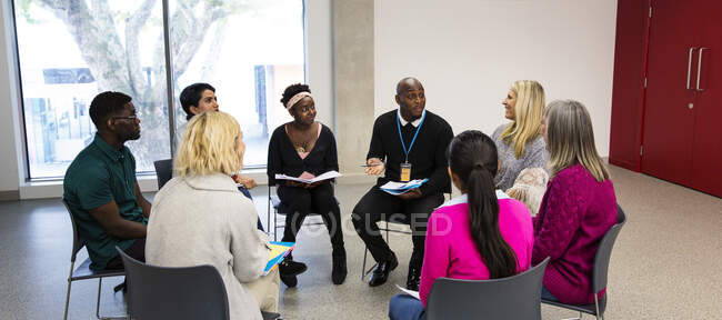 People talking in support group meeting circle in community center — Stock Photo