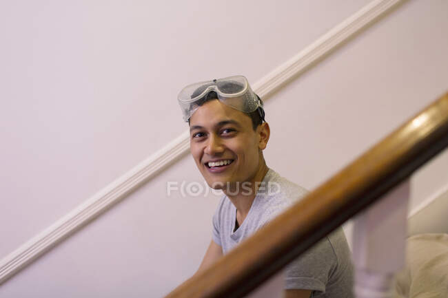 Portrait happy, confident man with goggles redecorating house — Stock Photo