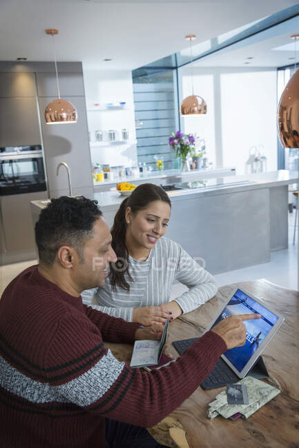 Couple with passports planning vacation at digital tablet — Stock Photo