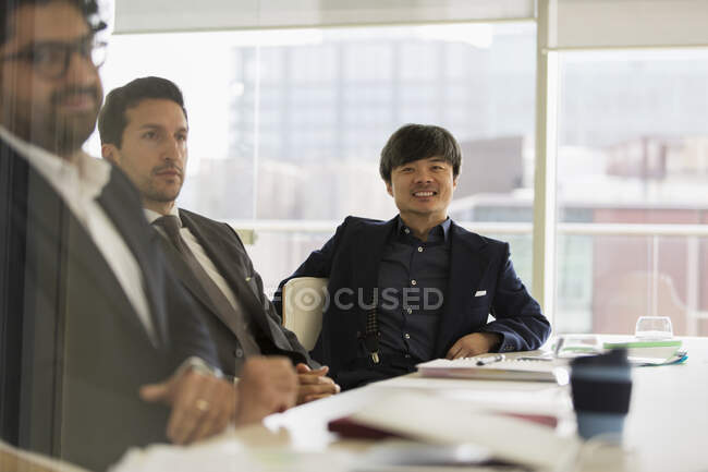 Portrait smiling businessman in conference room meeting — Stock Photo
