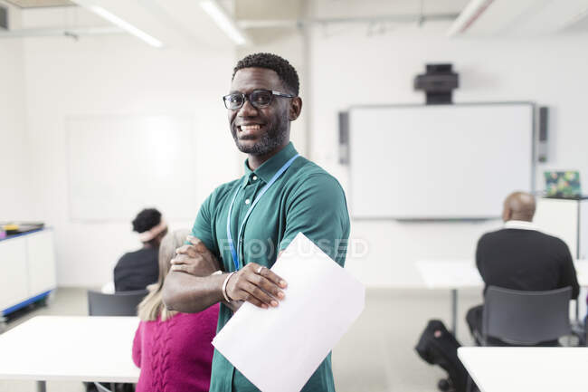 Portrait smiling, confident male community college instructor in classroom — Stock Photo