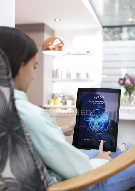 Girl logging on to digital tablet with face recognition — Stock Photo