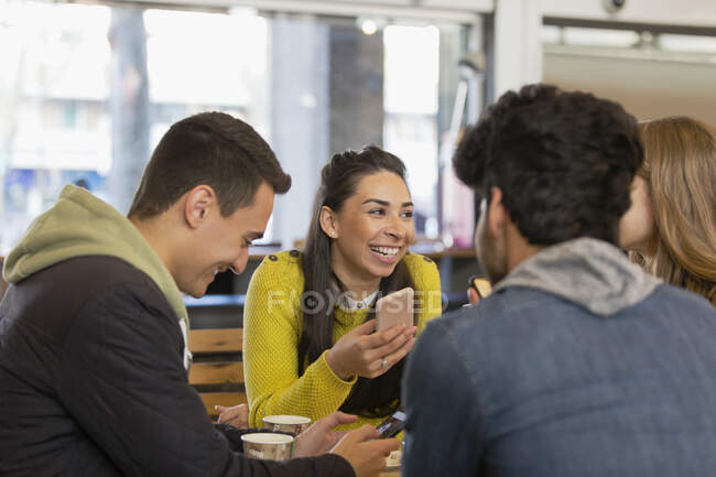 Happy young adult friends in cafe — Stock Photo