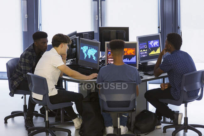 Junior high boy students using computers in computer lab — Stock Photo