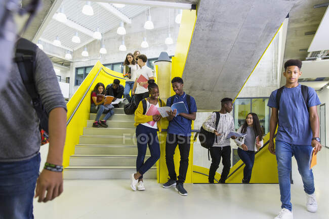 Junior high students hanging out on stairs — Stock Photo