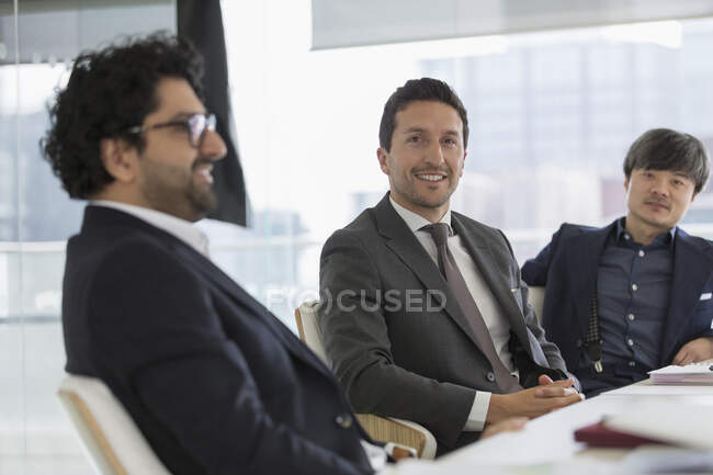 Portrait confident businessmen in conference room meeting — Stock Photo