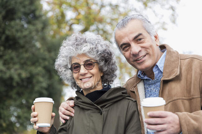 Portrait smiling, confident senior couple drinking coffee — Stock Photo