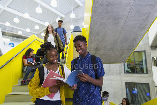 Junior high students studying at stairs — Stock Photo