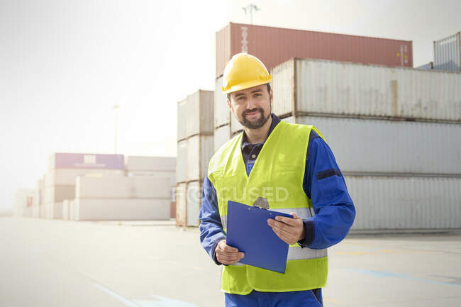 Portrait confident dock worker with clipboard at shipyard — Stock Photo
