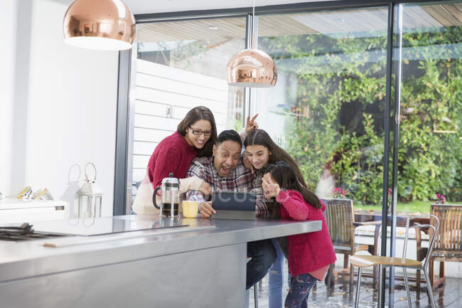 Playful family taking selfie with digital tablet in morning kitchen — Stock Photo