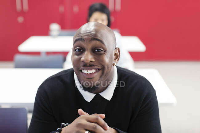 Portrait happy, confident male community college student in classroom — Stock Photo