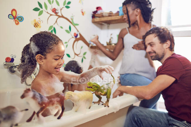 Беременные родители купают дочерей в пене — стоковое фото