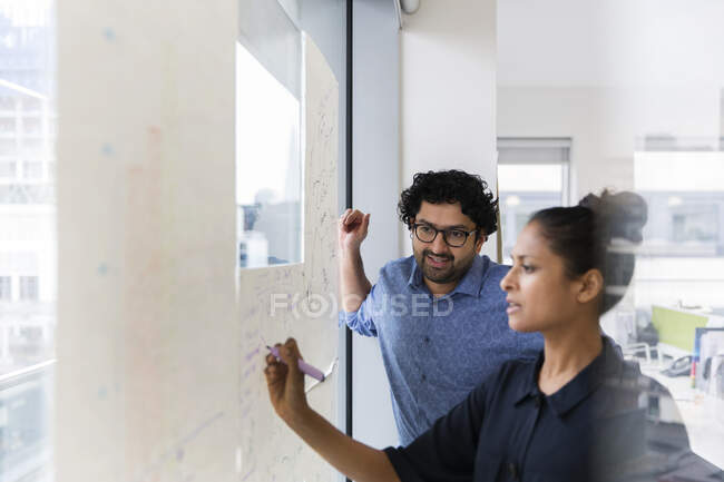 Gente de negocios lluvia de ideas en la oficina - foto de stock