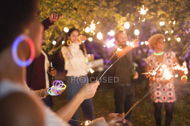 Amici con scintille godendo festa in giardino — Foto stock