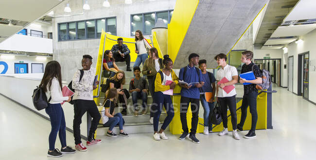 Junior high students hanging out at stairs — Stock Photo