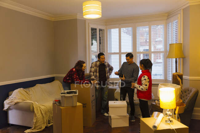 Friends taking a break from moving, celebrating with champagne — Stock Photo