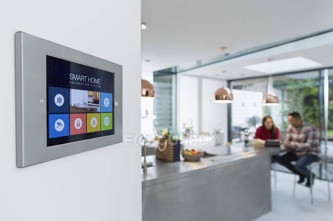 Smart home navigation system touch screen on kitchen wall — Stock Photo