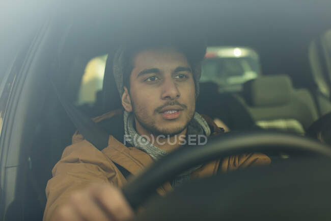 Young man driving car — Stock Photo