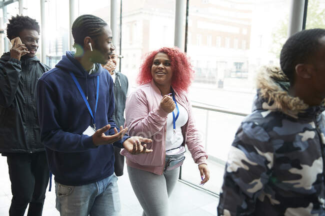 College students talking and walking in corridor — Stock Photo