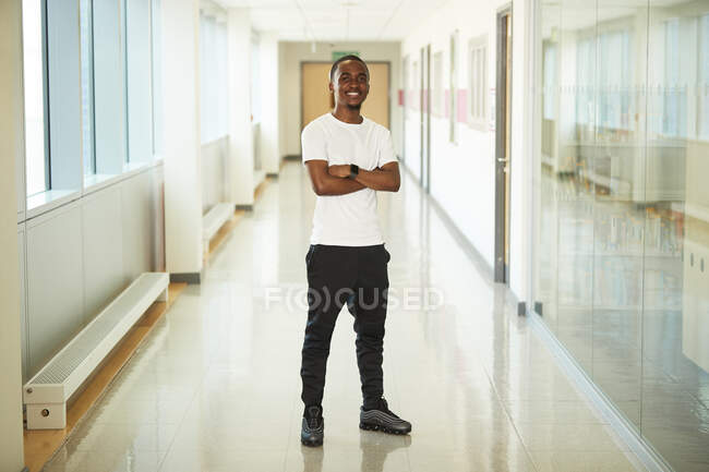 Portrait confident male college student in corridor — Stock Photo