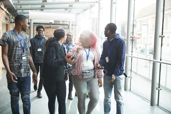 Estudantes do ensino médio conversando e andando no corredor — Fotografia de Stock