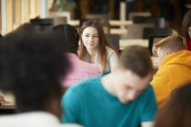 Young female college student listening to classmate — Stock Photo