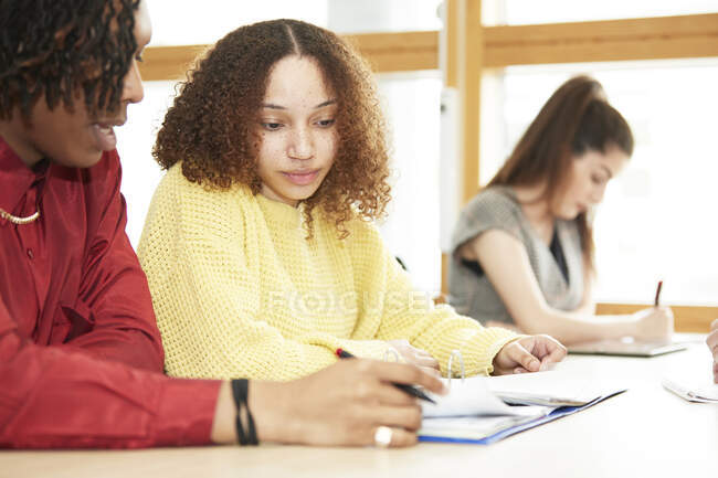 Focused college students studying together in classroom — Stock Photo