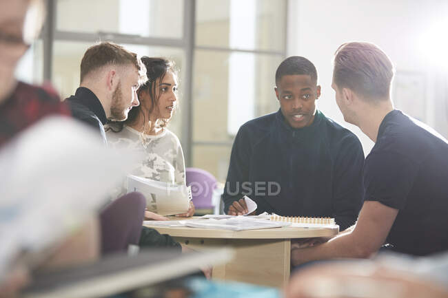 College students talking and studying in classroom — Stock Photo